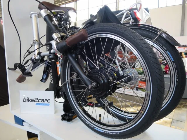 E-bike szerviz technikus elektromos kerékpáron dolgozik szakmai rendezvényen